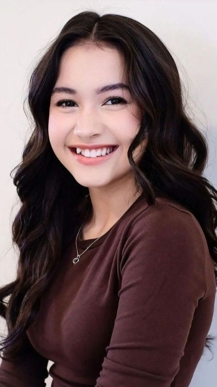 Smiling woman whose uneven teeth affect her smile's appearance